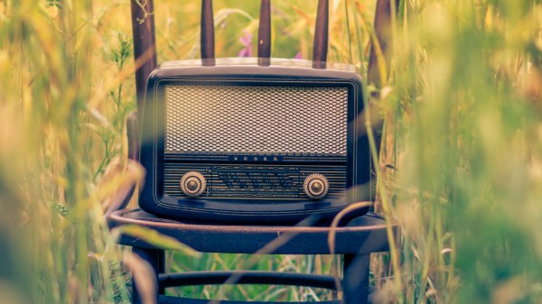 Clock radio on a chair in a field