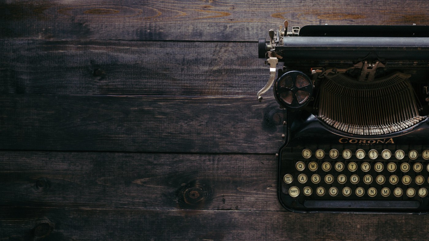 Old Corona typewriter on wooden desk